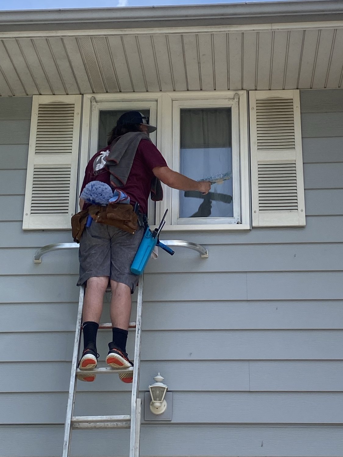 Window cleaning from a ladder