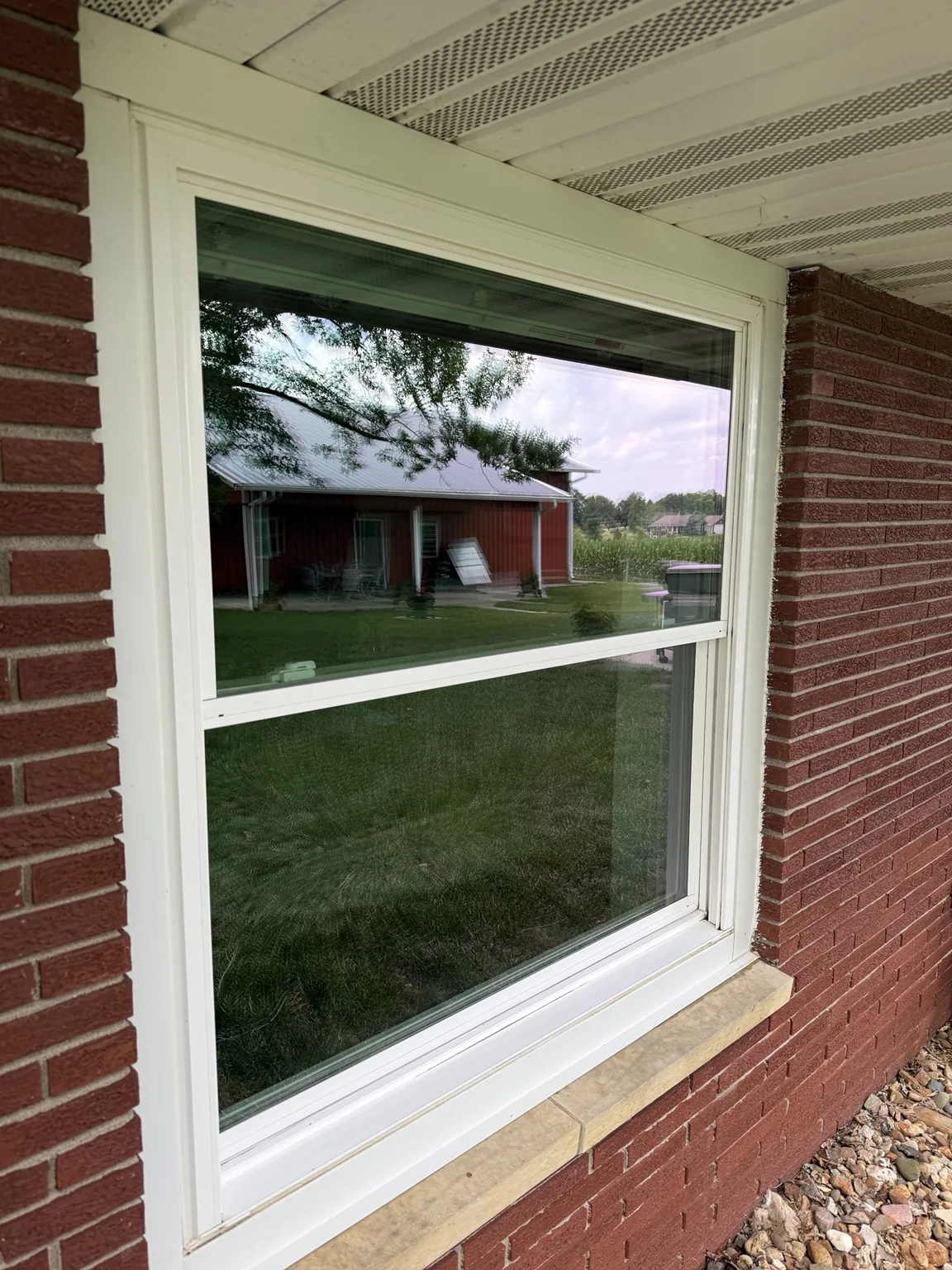 Clean window on brick home with clear reflection